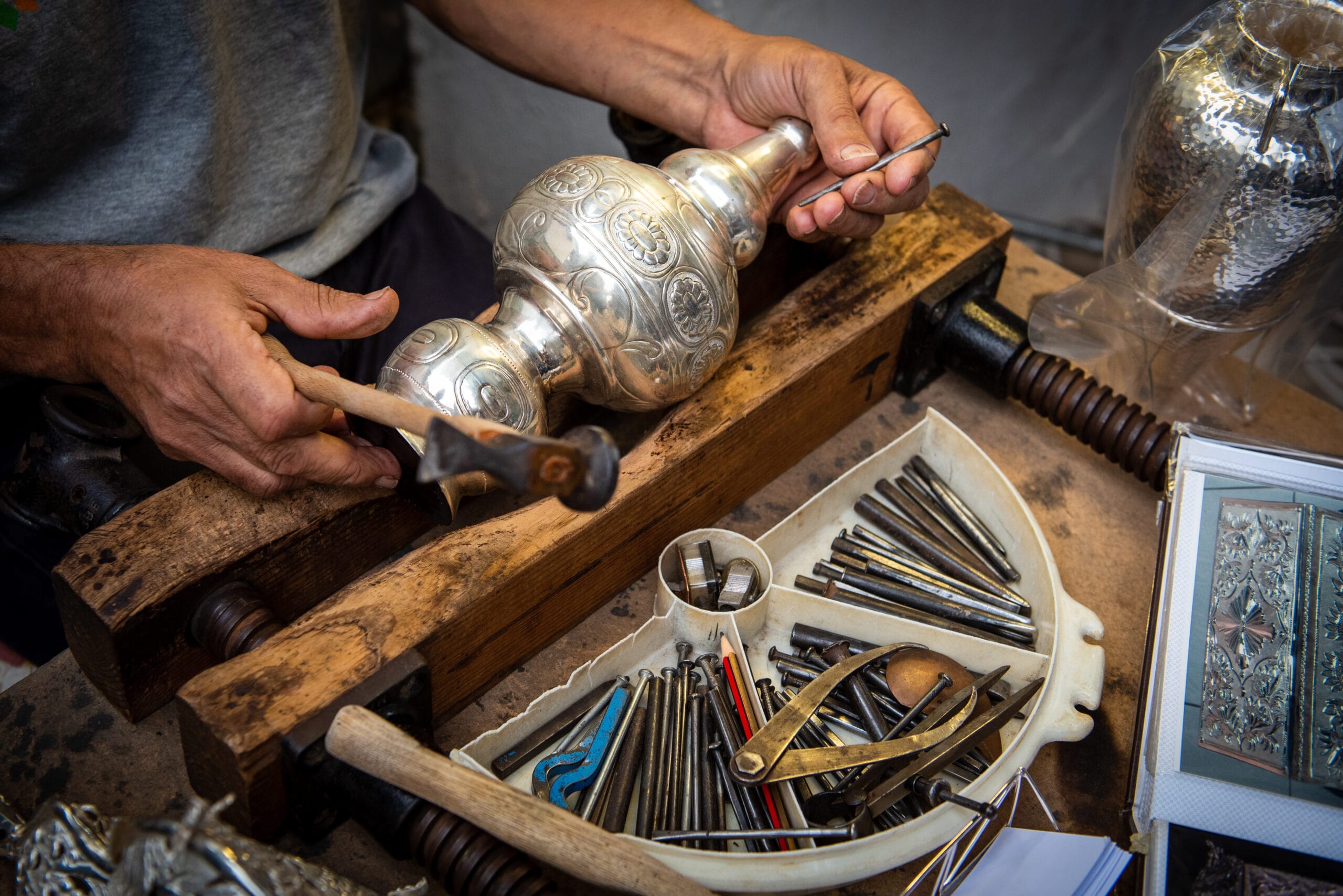 Moroccan artisan working by hand with traditional tools during a local craft workshop experience