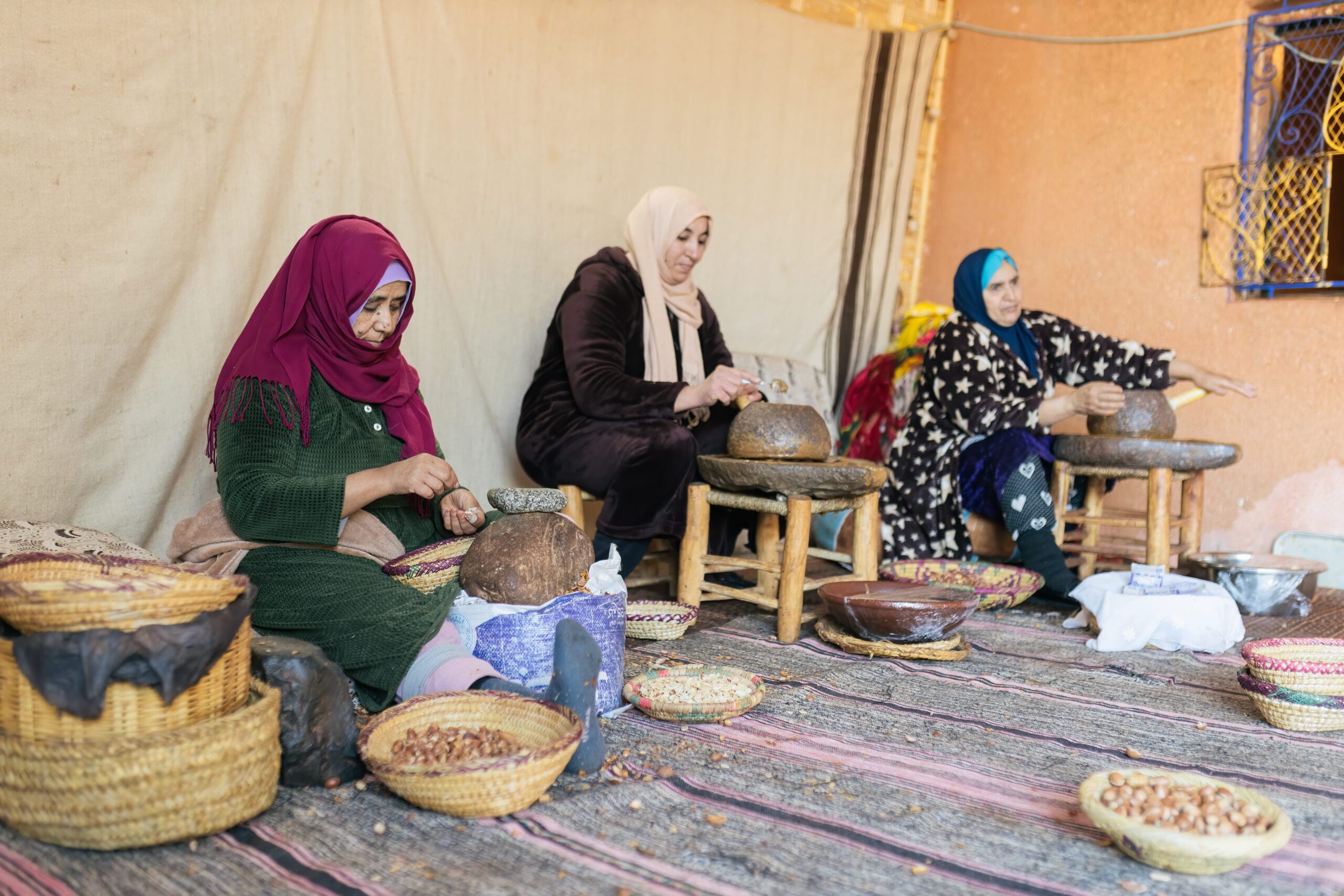 Moroccan woman producing argan oil by hand in a traditional setting